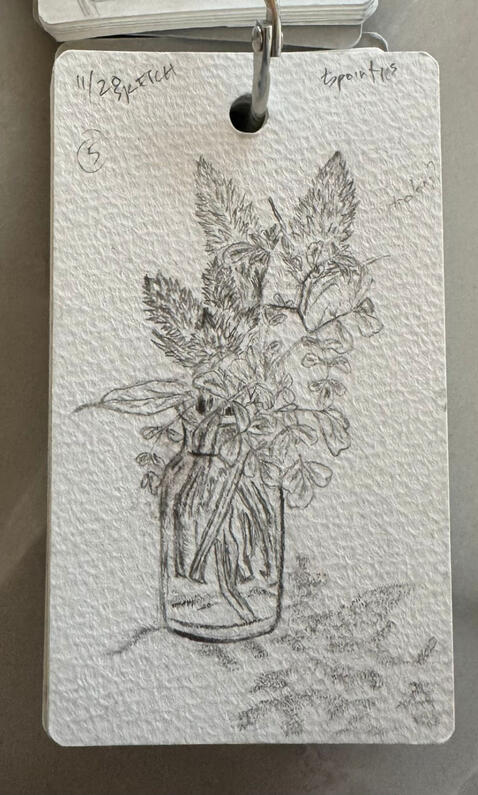 cafe visit: centerpiece on table, mini sketchbook, pencil, dated 11/20. flowers in a small glass bottle
